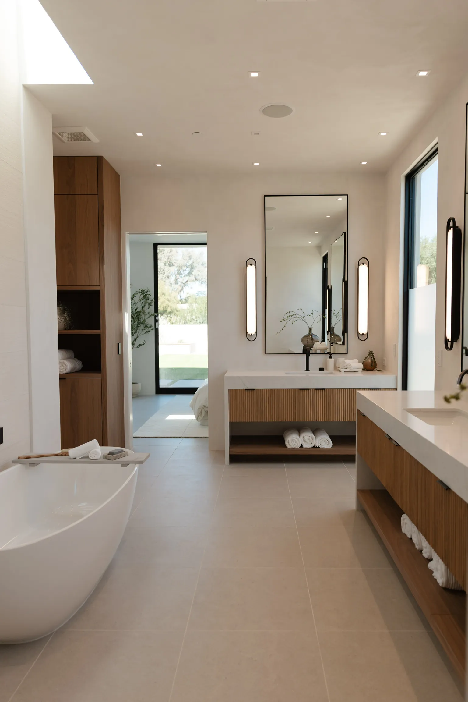 Primary bath with freestanding tub and walnut vanity