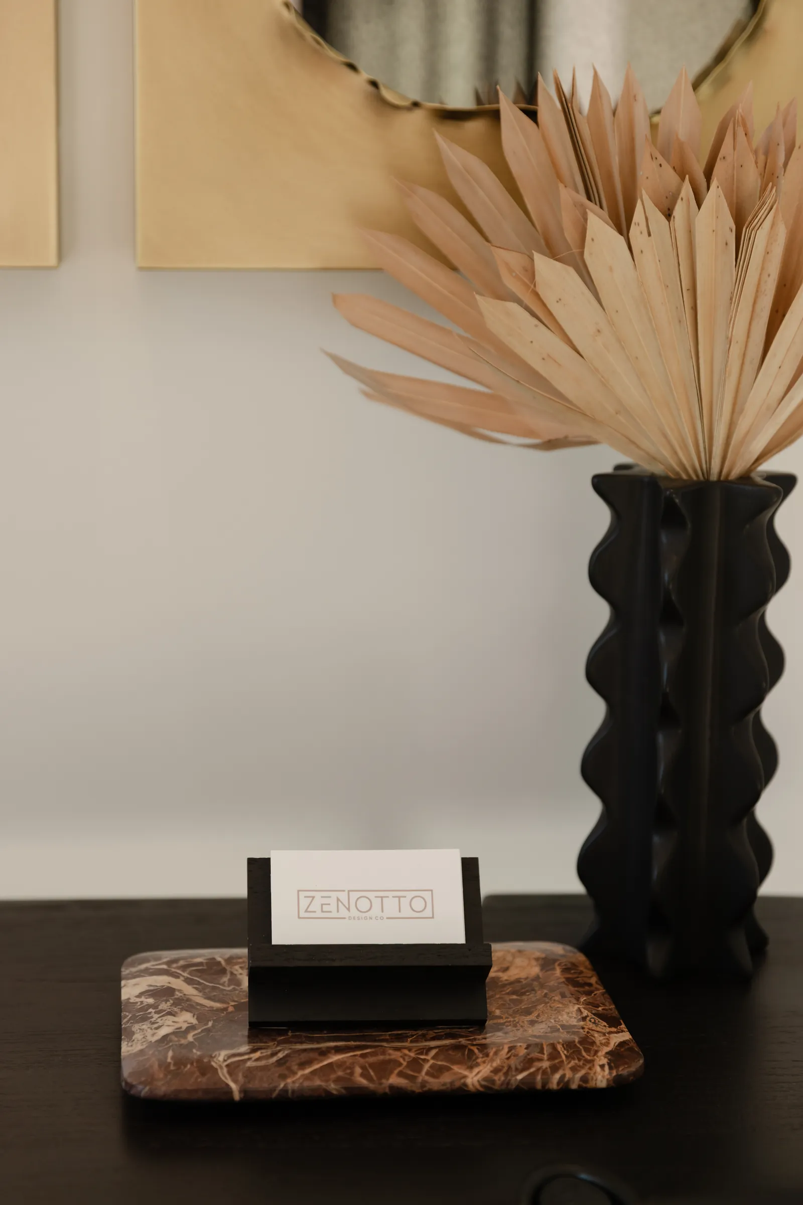 Console styling with dried palms and a sculptural vase