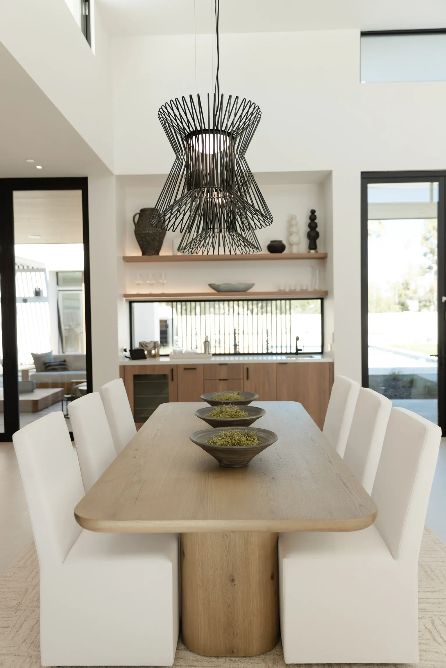 Dining room beneath a sculptural chandelier