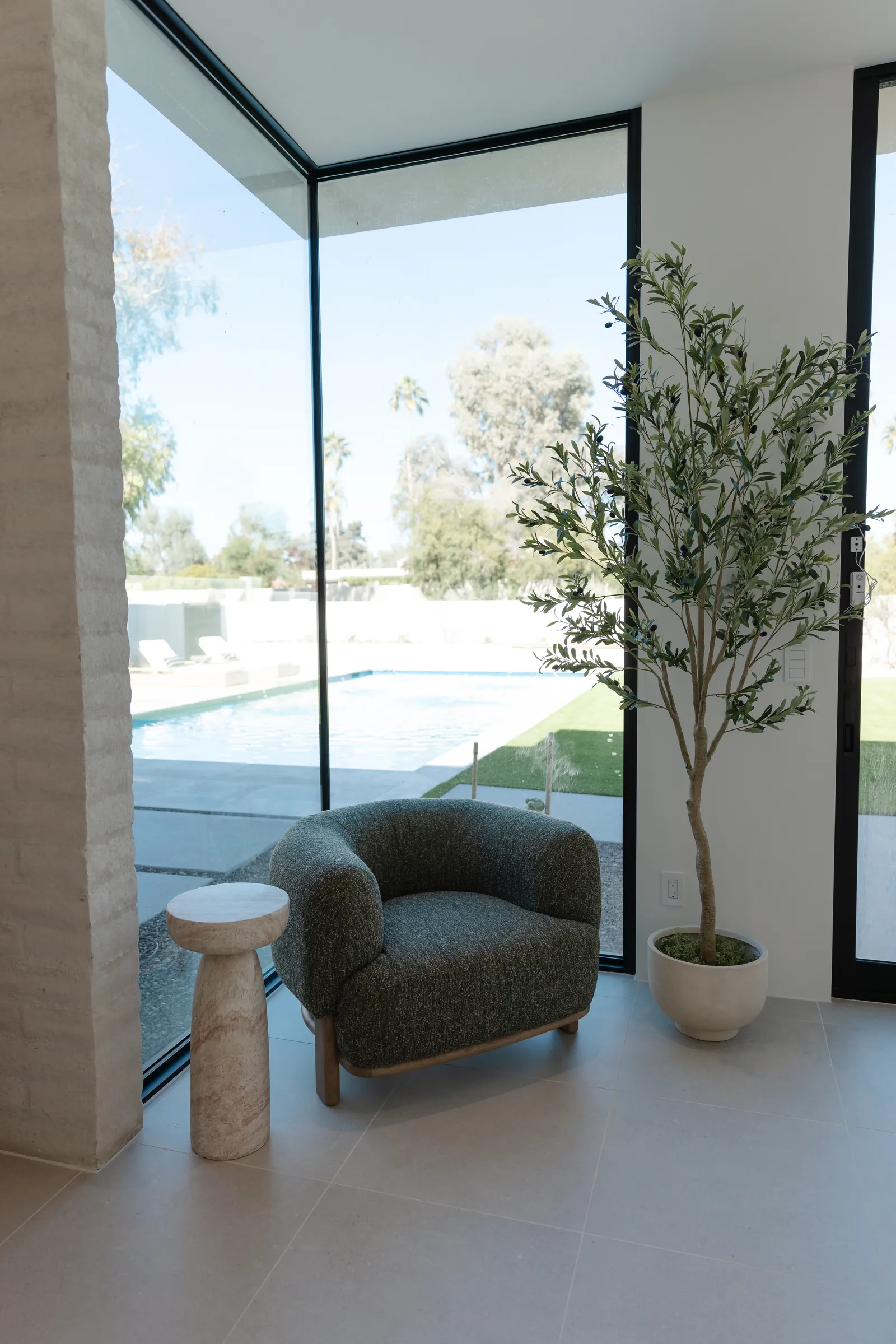 Corner window seating with a view to the pool